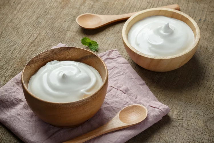 Plain yogurt, mix with a little bit of lemon juice or vinegar to achieve a similar consistency